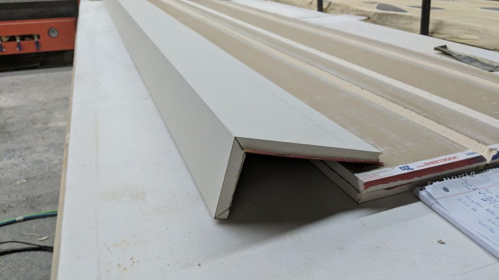 Right angle corner piece made from prefabricated drywall sitting on drywall