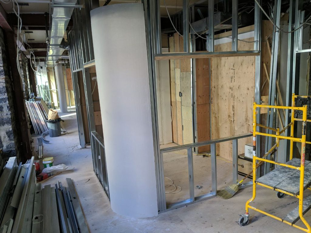Rounded corner made from prefabricated drywall on an unfinished wall in an apartment building